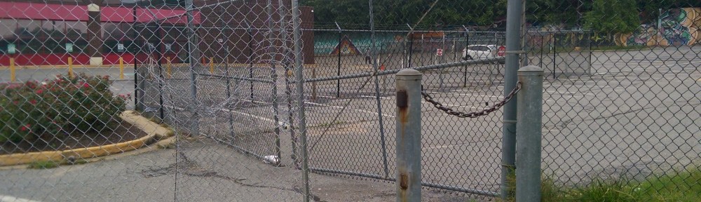Chain Link Fence with hole ripped into it.