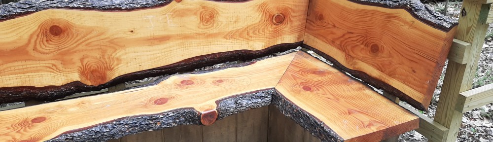 Image of L-shaped bench made out of cut logs