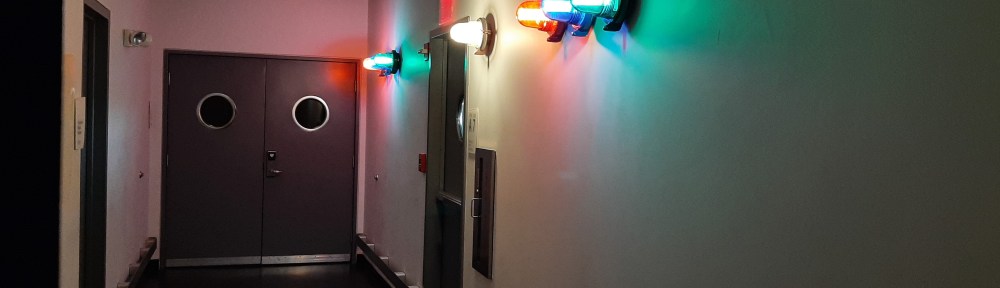 Hallway outside recoding studio with some lights on wall.