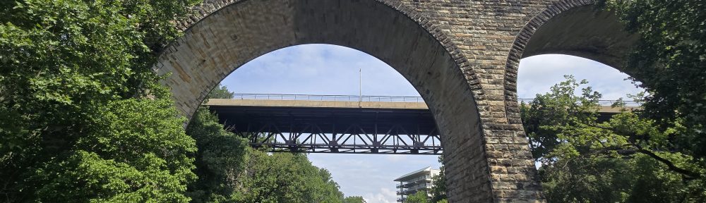Image of a stone arch over the Brandywine river and park in Wilmington Delaware